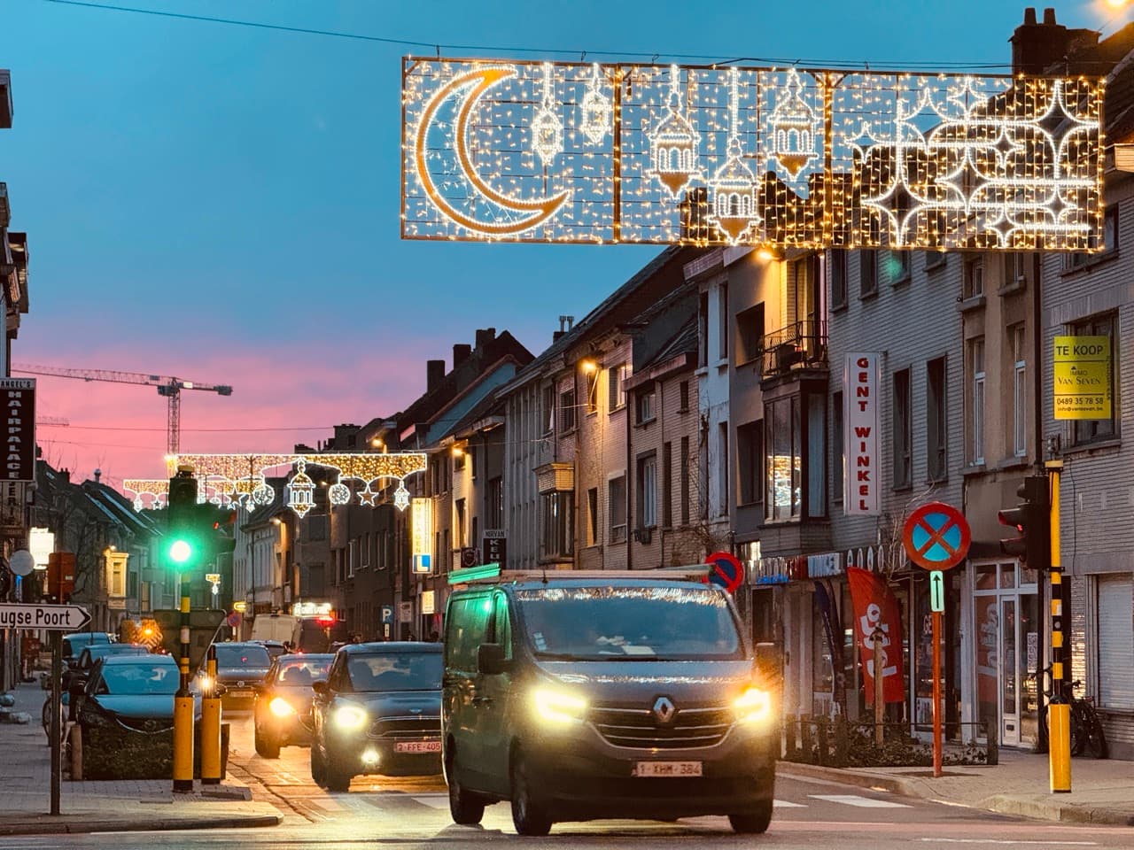 Ramadan verlichting Gent — verlichte halve maan, minaretten en lantaarns boven de Brugse Poort bij schemering
